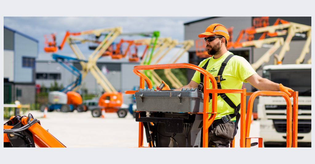 Engineer working at height in the sun on a cherry picker 